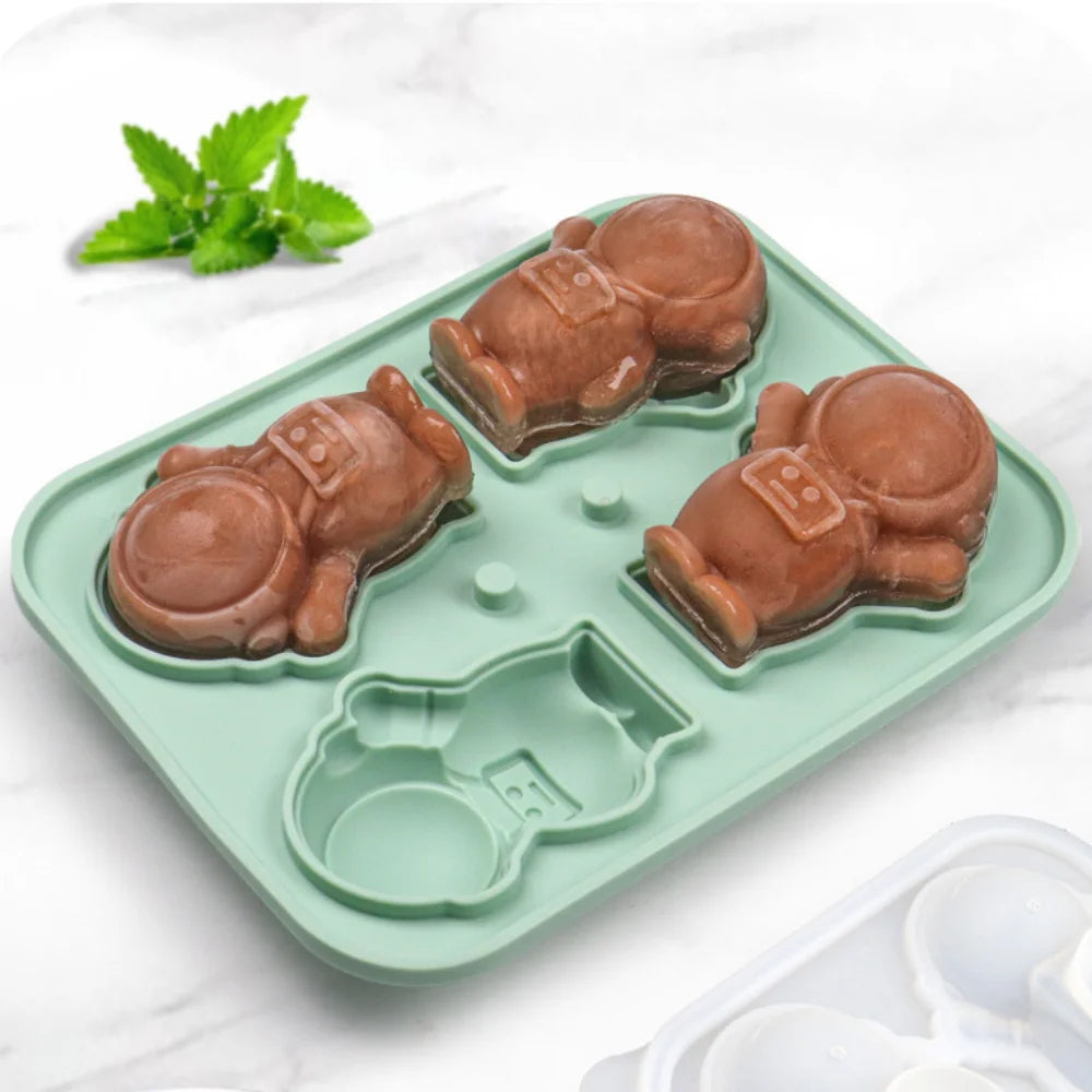 Green 3D astronaut silicone mold with three slots for creating astronaut-shaped ice, chocolate, or candy treats. Ideal for adding a fun, space-themed touch to desserts and drinks. Easy to use and perfect for creative kitchen projects.