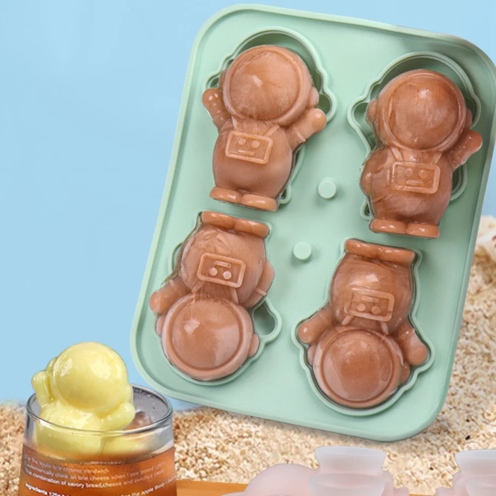 3D astronaut-shaped silicone ice cube mold with four slots. Perfect for creating astronaut-shaped ice cubes for drinks, desserts, or fun snacks. Mold features adorable astronaut figures and is easy to use for creative food presentations.